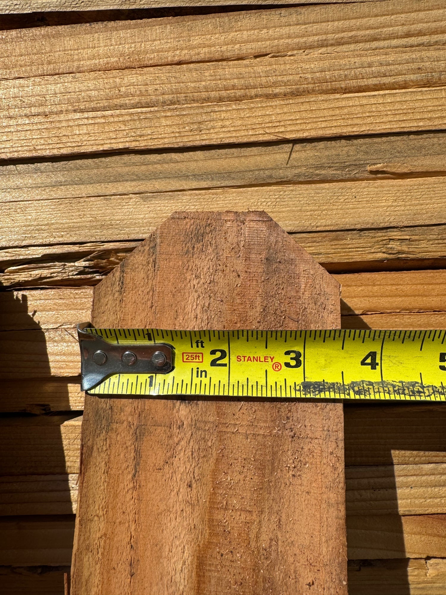 Front detail of dog-ear redwood fence picket showing that the board is 3.5" wide